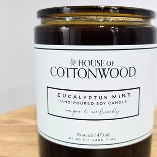 Candle jar with 'House of Cottonwood' label with a bamboo lid