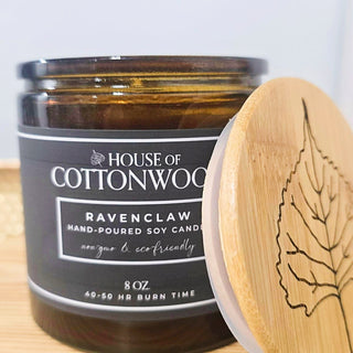 Candle with 'House of Cottonwood' label and bamboo lid