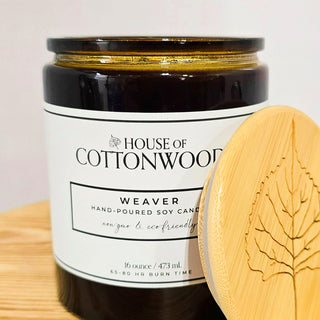 Candle jar with bamboo lid labeled 'House of Cottonwood' on a light background